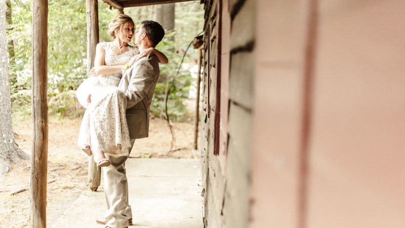 A bride holding his just outstandingly awesome bride just after their ceremony - campground wedding - Hanson - Camp Kiwanee - Wedding Photography