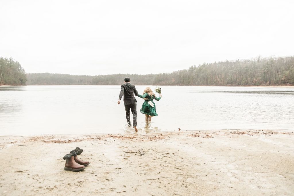 Adventurous fall elopement at Walden Pond with bride in forest green dress running into the water | Wedding photography in Boston and Massachusetts