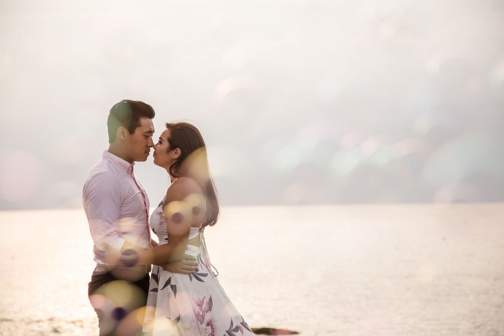 A couple surrounded by bubbles during an engagement session at Stage Fort Park in Gloucester, MA.