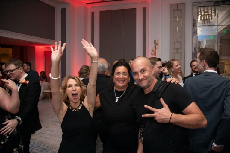 Boston wedding photographer Aaron of Spagnolo Photography poses with two wedding guests on the dancefloor of a Langham Boston wedding.