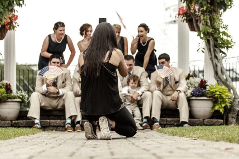 Nanore of Spagnolo is photographed photographing a bridal party at a Danversport Yacht Club wedding - the image is featured on Spagnolo Photography's "About Us" page.