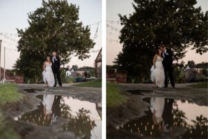 A bride and groom stand under string lights at dusk, their reflection mirrored in a puddle, shot by creative wedding photographers Spagnolo Photography at the Barn at Gibbet Hill wedding in Groton, MA.