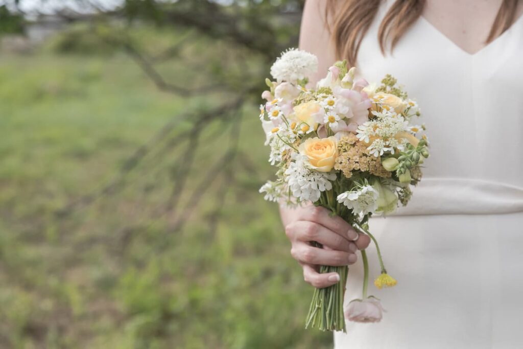 A bride holds a simple and elegant bouquet at her elopement on Martha's Vineyard - photo featured in bride's review of Massachusetts wedding photographer Spagnolo Photography