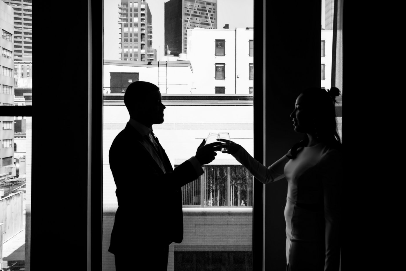 Bride and groom toasting at the Godfrey Hotel before heading to Boston City Hall to elope