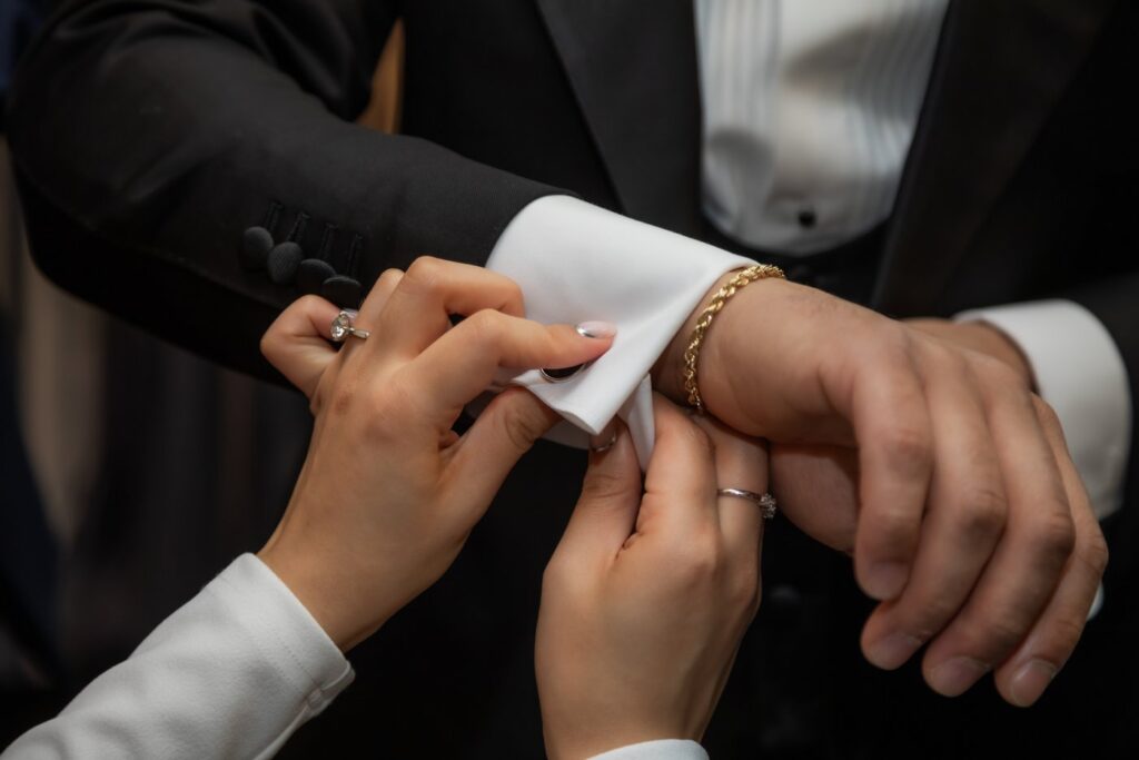 Groom getting fitted for cufflinks at Cuffs & Collars by Antoine Rubini in Boston