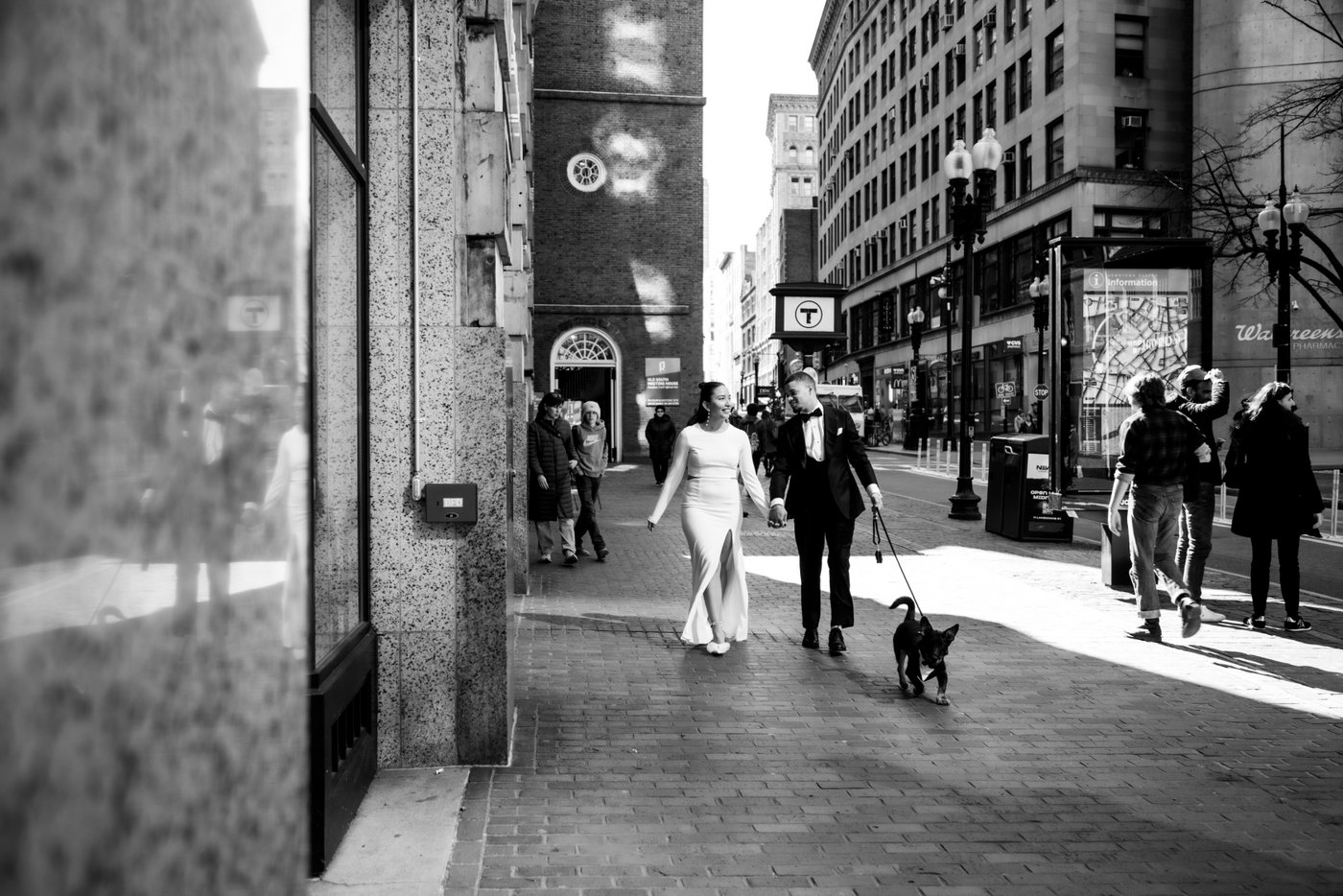 Bride and groom walking through Boston on their way to get married at Boston City Hall