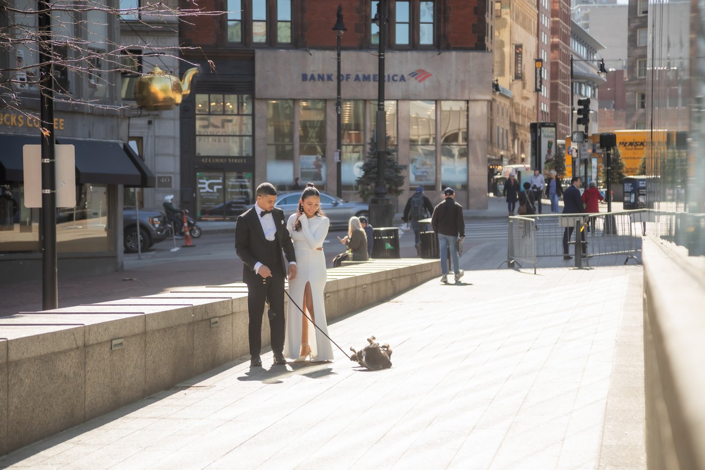 Bride and groom walking through Boston on their way to get married at Boston City Hall