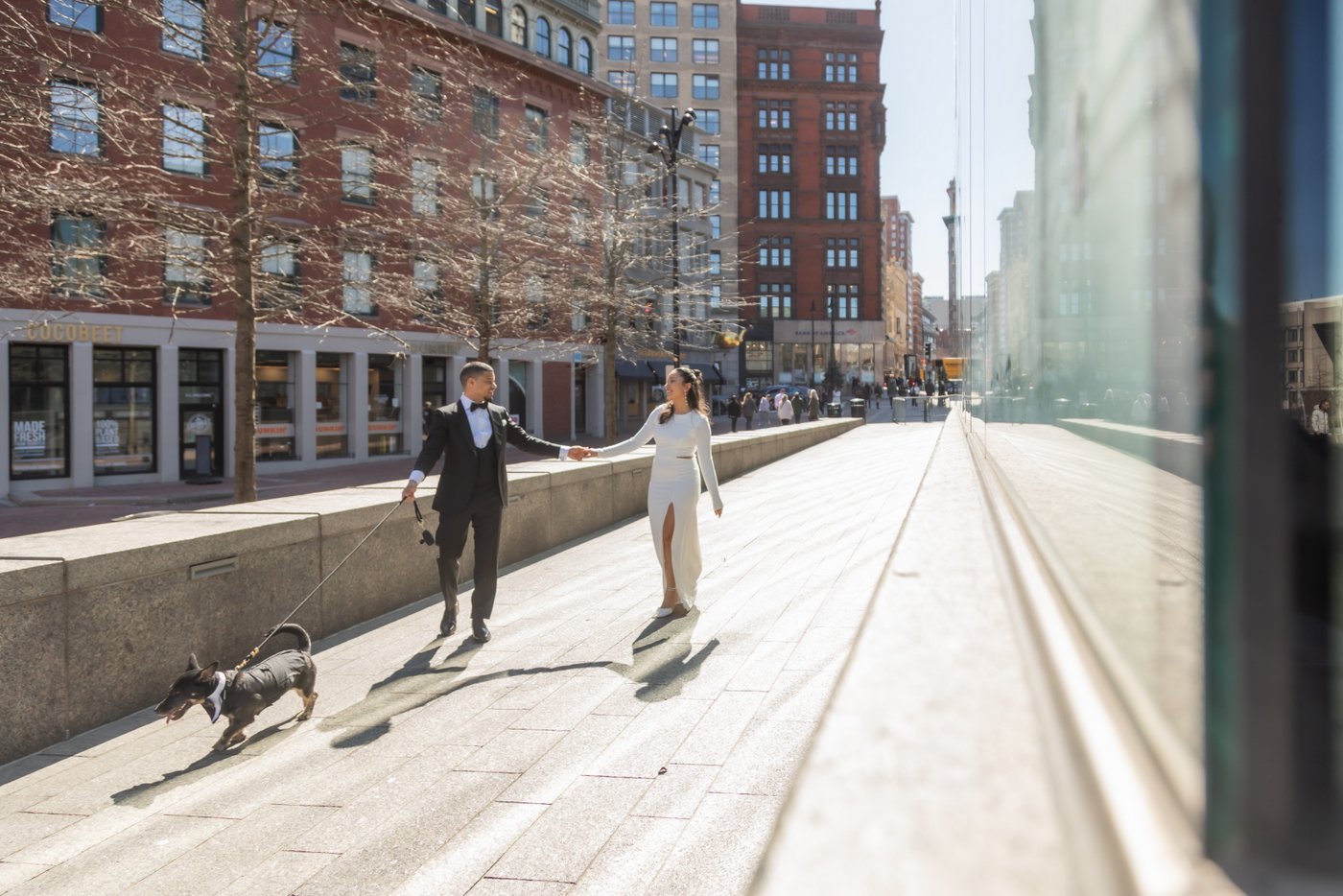 Bride and groom walking through Boston on their way to get married at Boston City Hall
