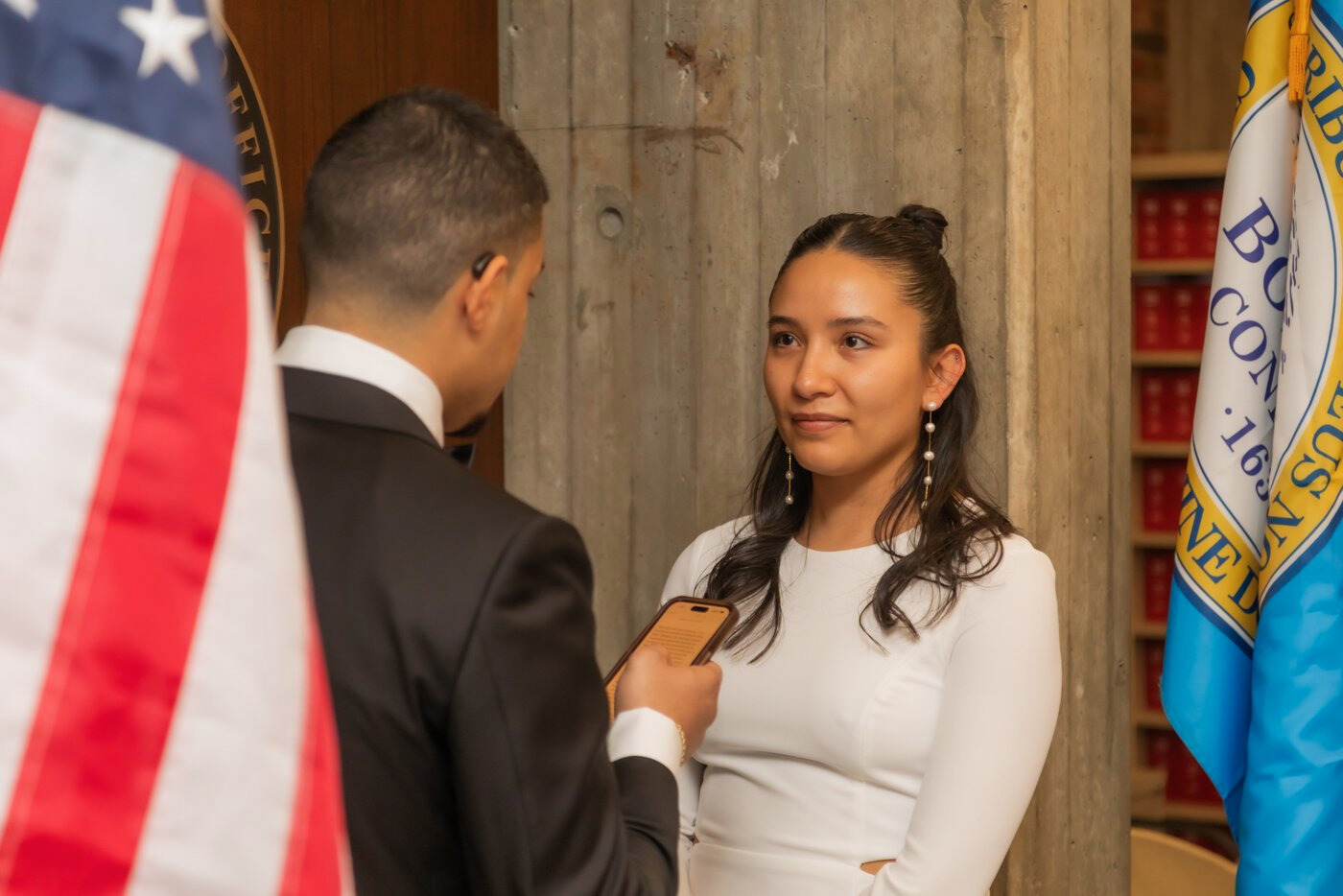 The bride looking at the groom lovingly as she reads her vows at Boston City Hall wedding