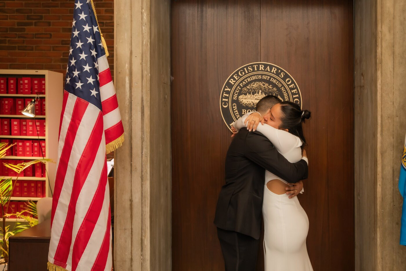 Bride and groom hug at Boston City Hall wedding ceremony