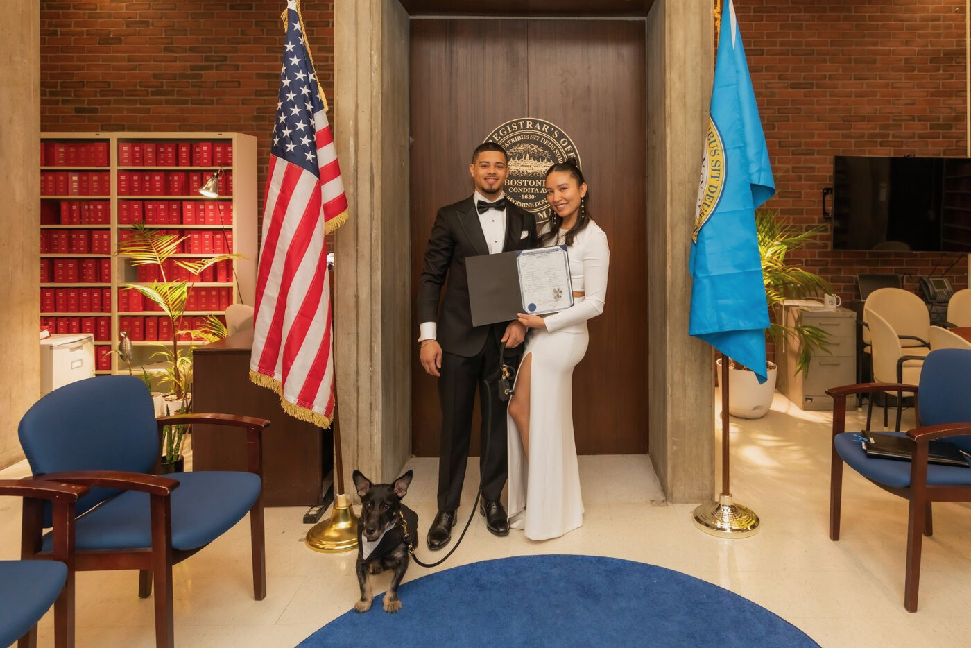 Bride and groom hold up their marriage license at Boston City Hall wedding