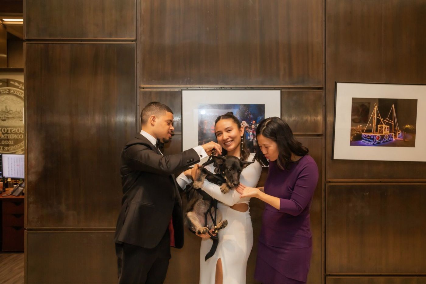 Mayor Michelle Wu petting the dog in a tux who served as witness during a Boston City Hall wedding