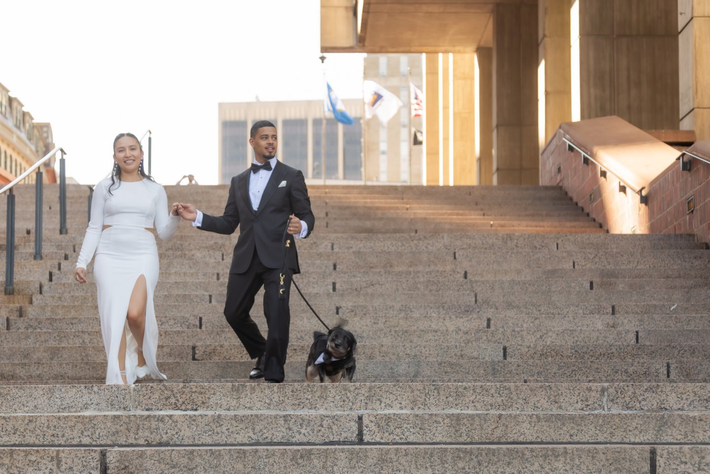 Bride and groom leaving Boston City Hall after their wedding there