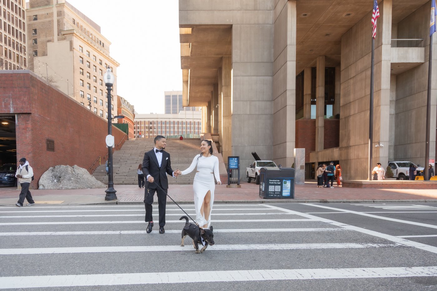 Bride and groom walking through Boston after getting married at Boston City Hall
