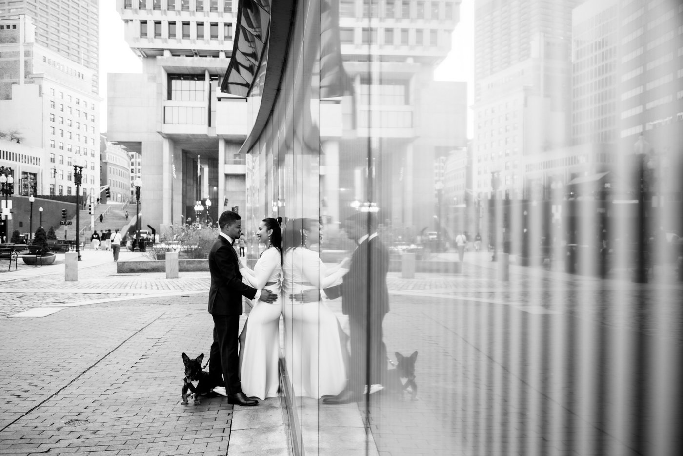 Bride and groom holding each other on a Boston street after getting married at Boston City Hall