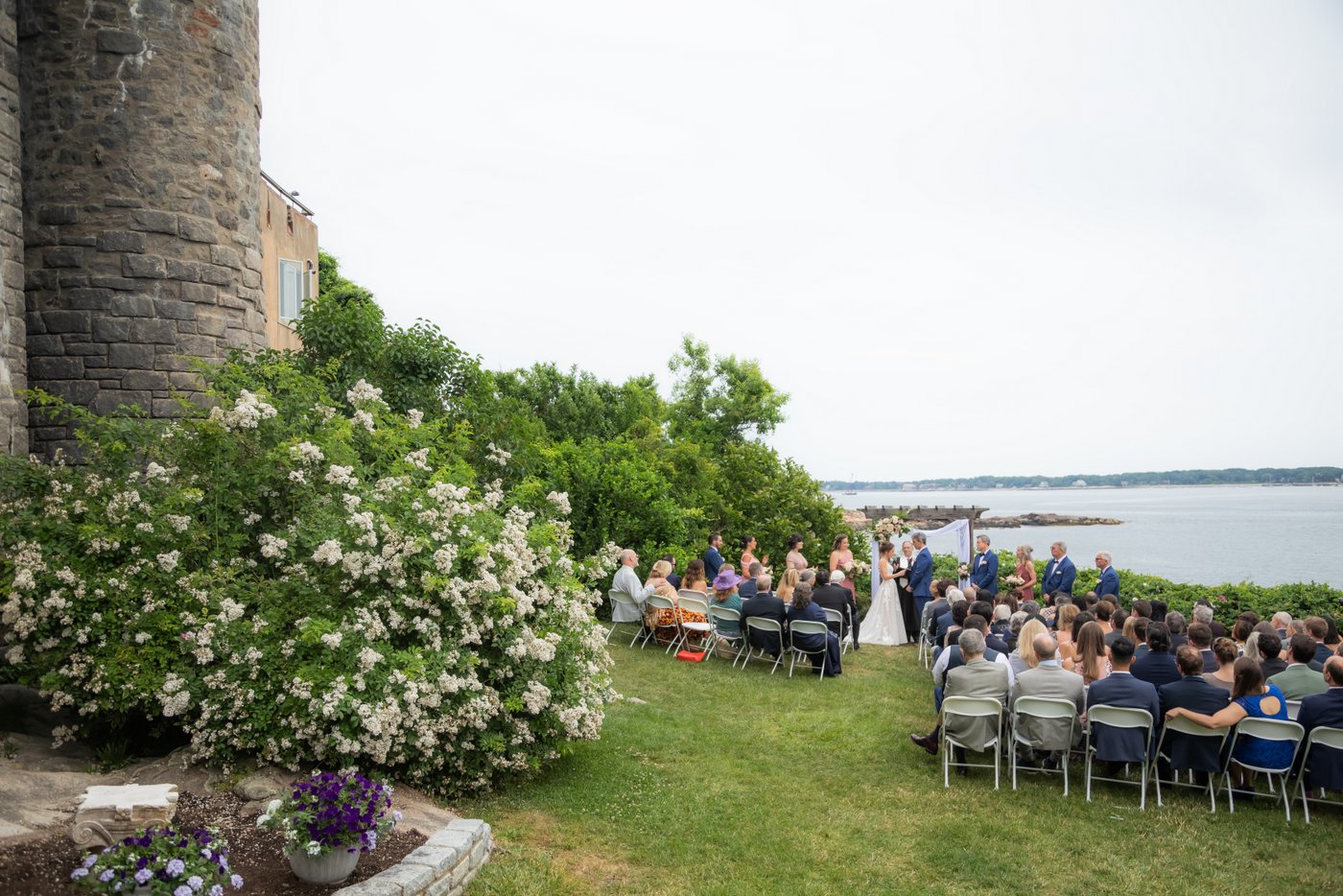 A wide angle shot of this summertime wedding ceremony at Hammond Castle