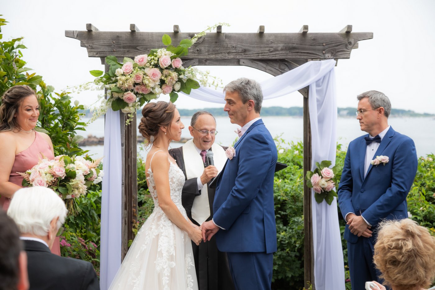 The bride and groom smile at each other just before their kiss at the altar