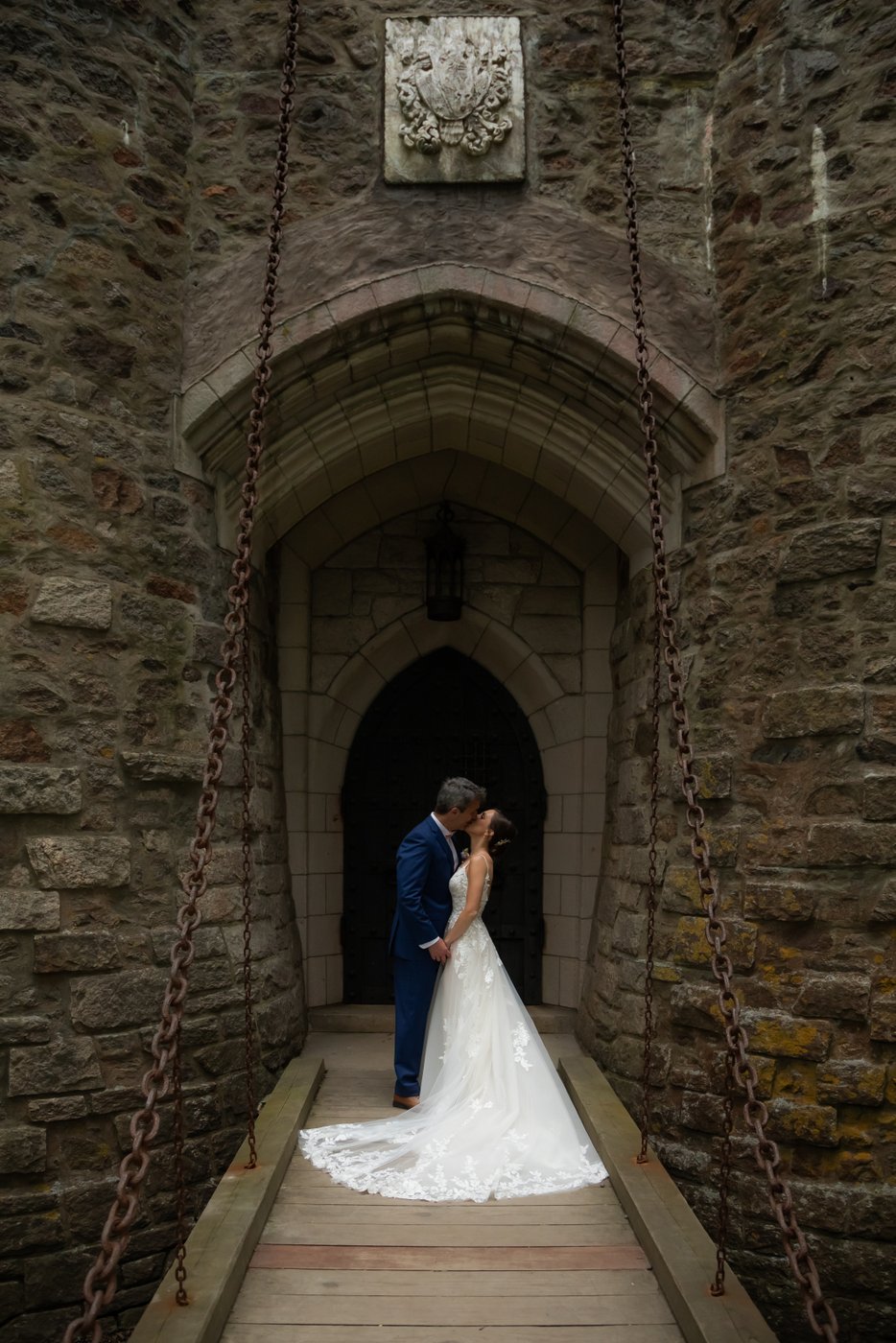 A portrait of the couple on the Hammond Castle drawbridge before their grand entrance into the wedding reception tent