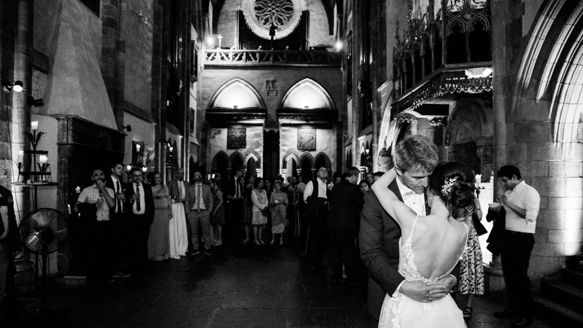 A dramatic black and white shot of the bride and groom during their first dance in the Great Hall at their summer Hammond Castle Museum wedding.
