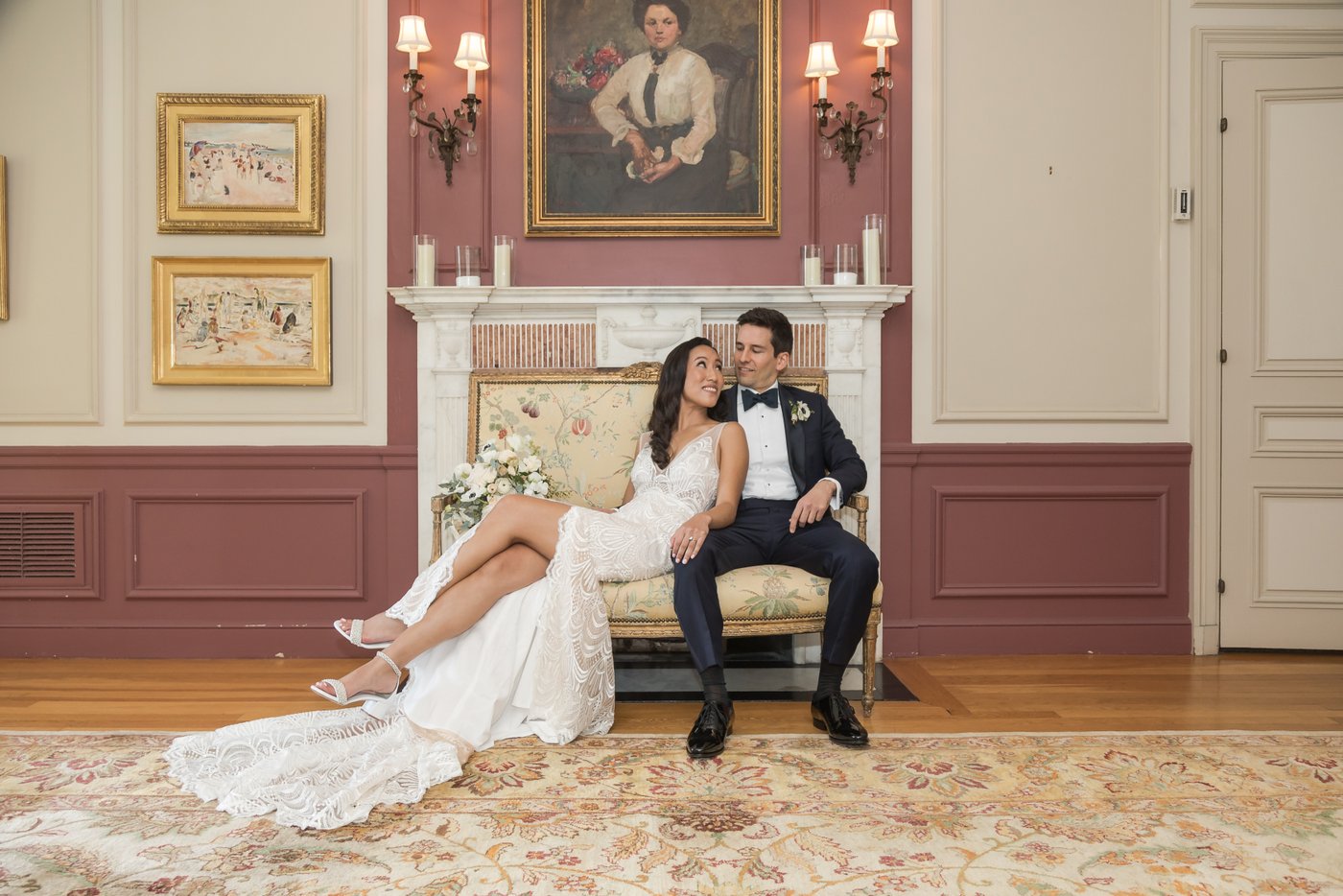 Wedding portrait of bride and groom on vintage couch inside Misselwood Estate mansion in Beverly MA