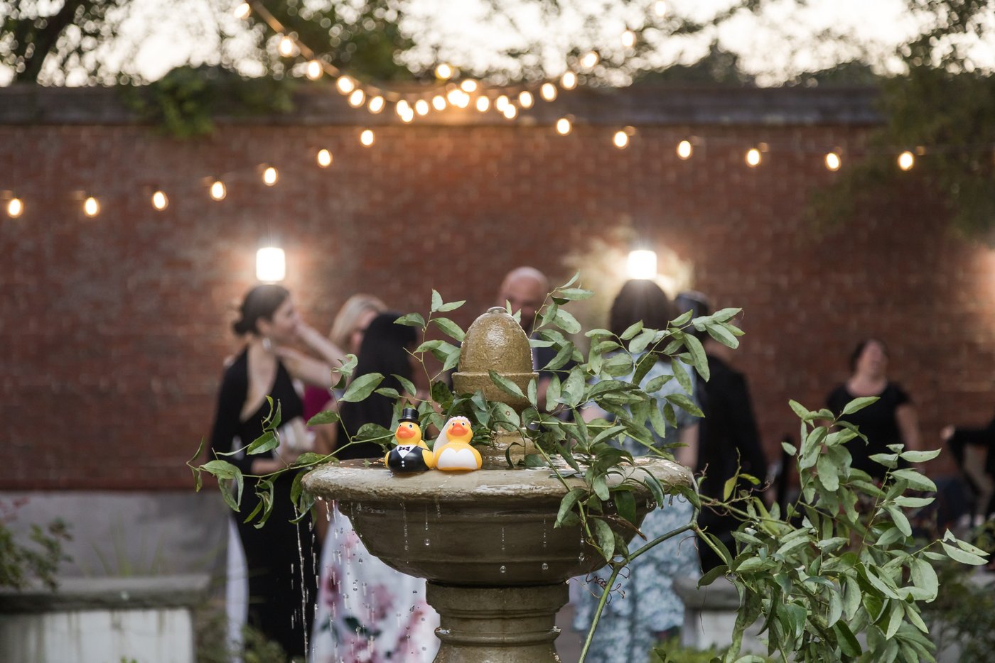 Courtyard cocktail hour with string lights and fountain at Misselwood Estate wedding