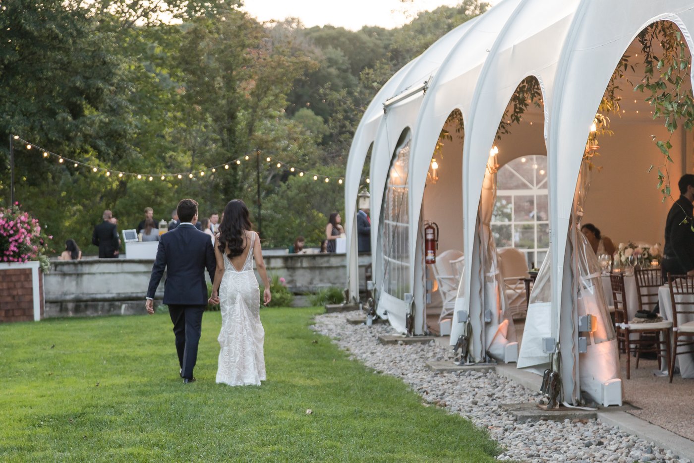 Candid shot of bride and groom walking away from the camera at Misselwood Estate wedding venue in Beverly MA