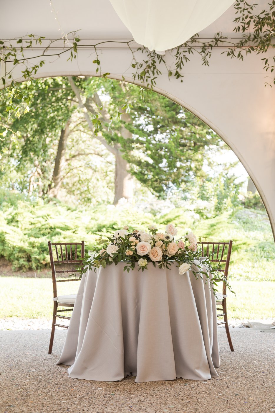 Elegant wedding sweetheart table setting with pastel lavender napkins and soft floral centerpieces at Misselwood Estate