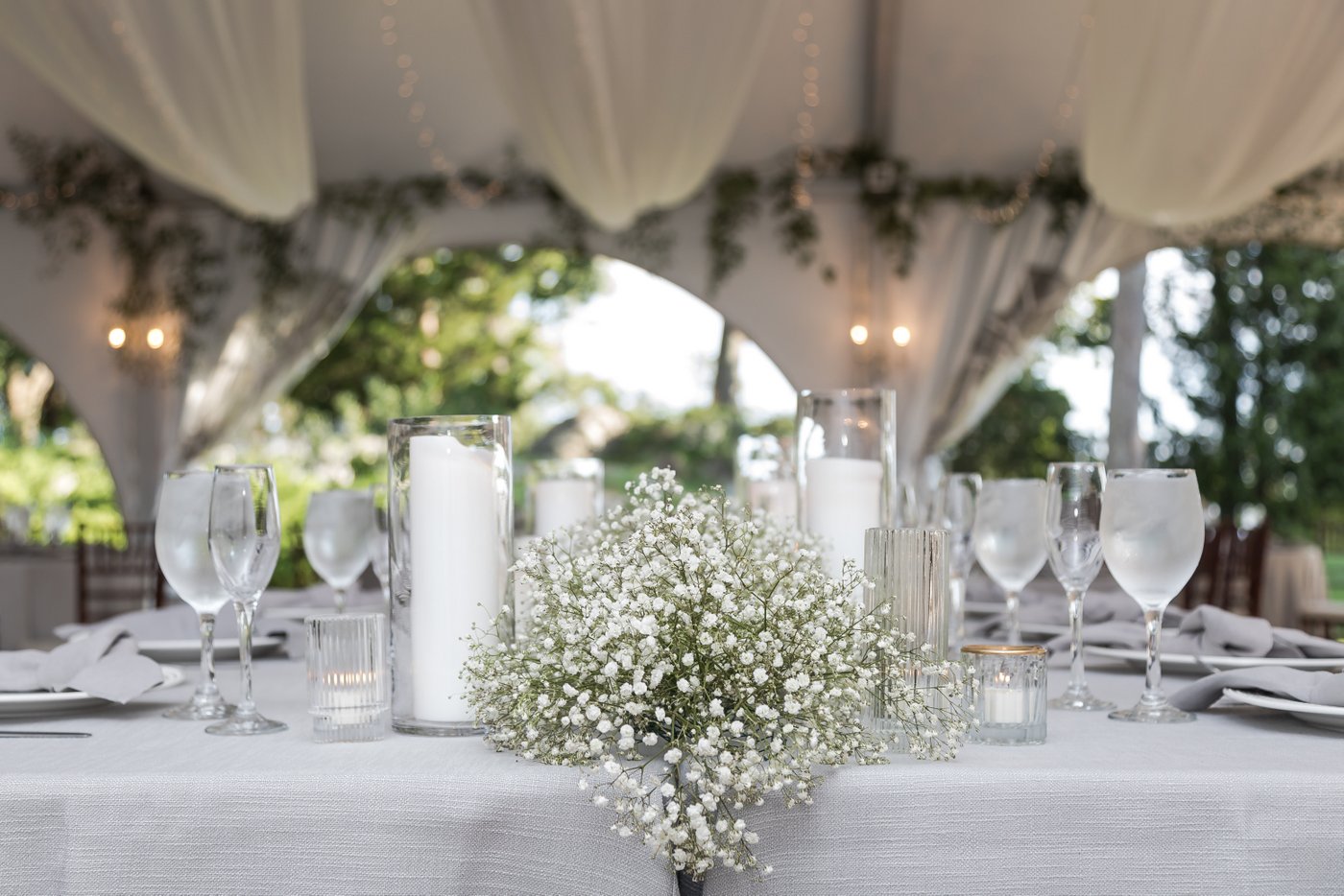 Tented Misselwood Estate wedding reception with pastel linens, candlelight, and seasonal florals