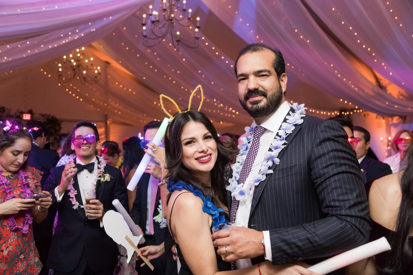 Guests dancing under string lights during La Hora Loca in tented Misselwood Estate wedding reception