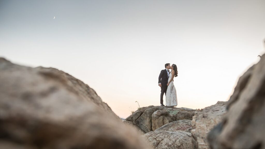 Bride and groom on the rocks at Misselwood Estate at sunset in Beverly MA