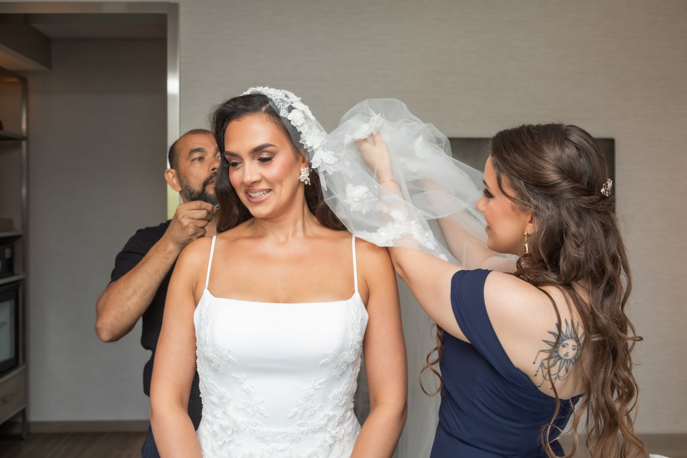 Bride’s veil being placed during the getting ready moments at a nearby hotel before her Nahant wedding on the beach.