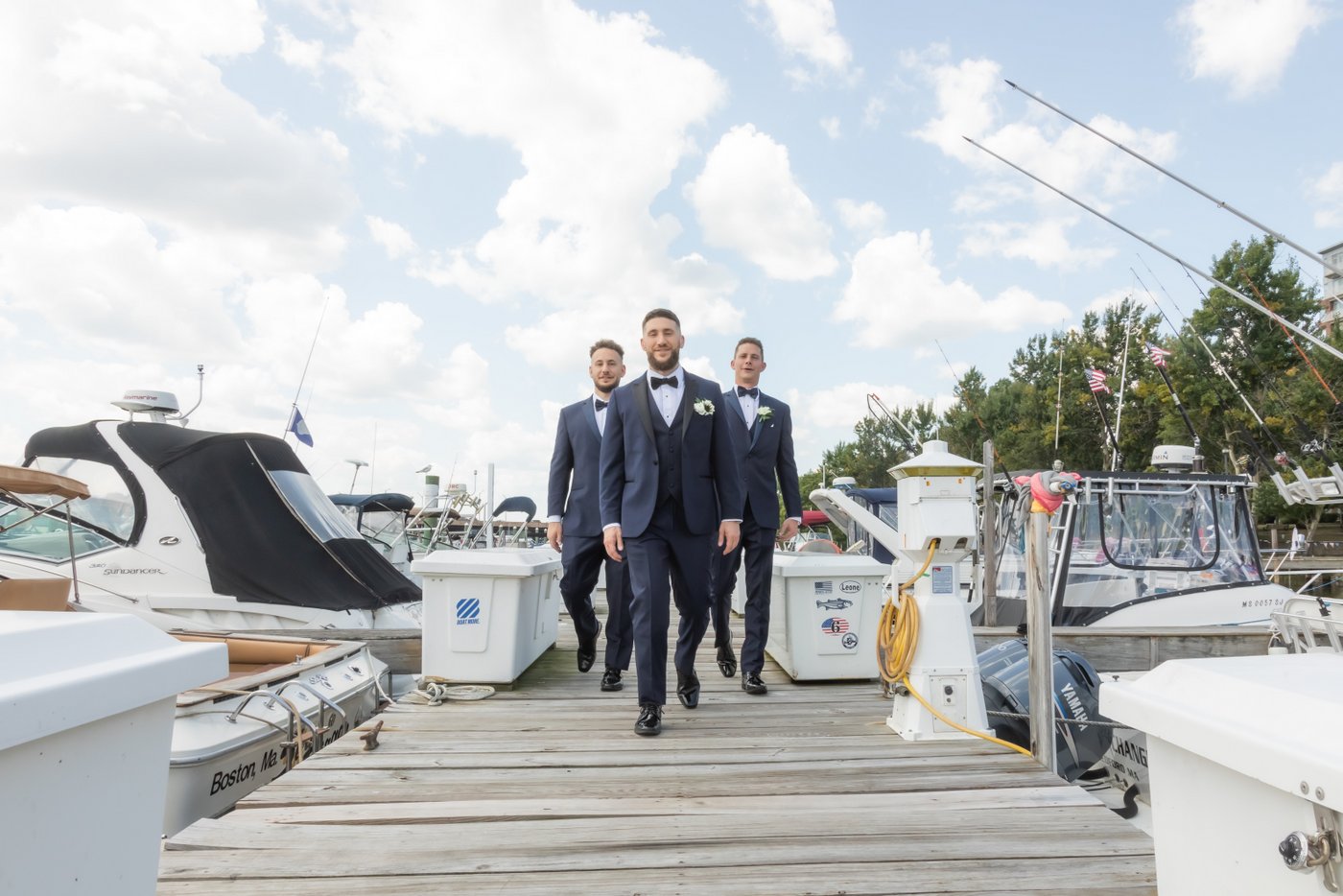 The groom and his groomsman walking down the dock