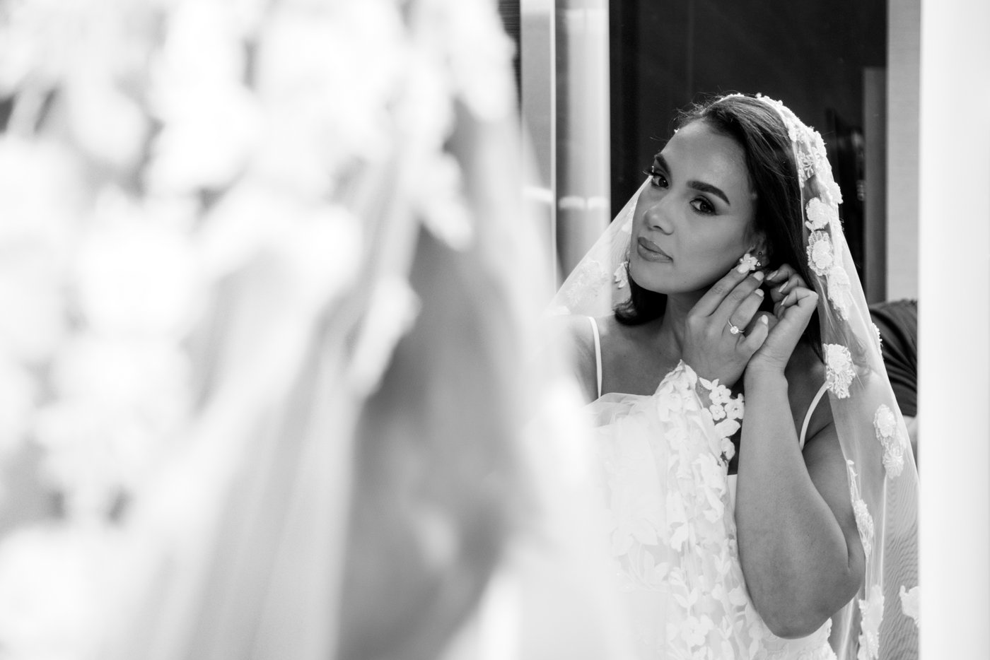 The bride adjusts her earing before heading out for her First Look at the AC Hotel Boston North