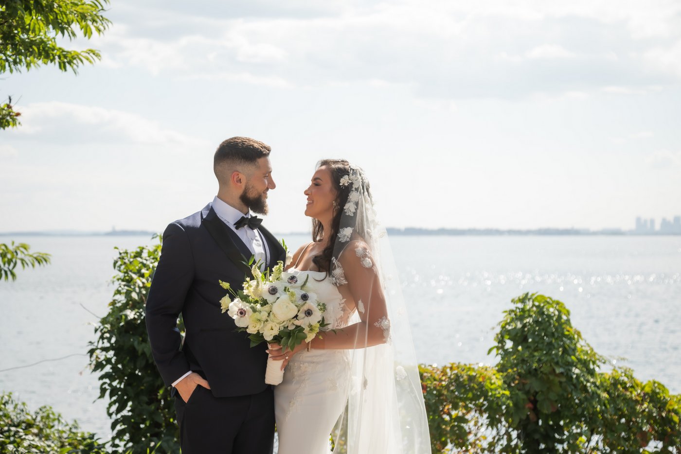 Portrait of the bride and the groom in front of the ocean in the park by Oceanview of Nahant on their wedding day