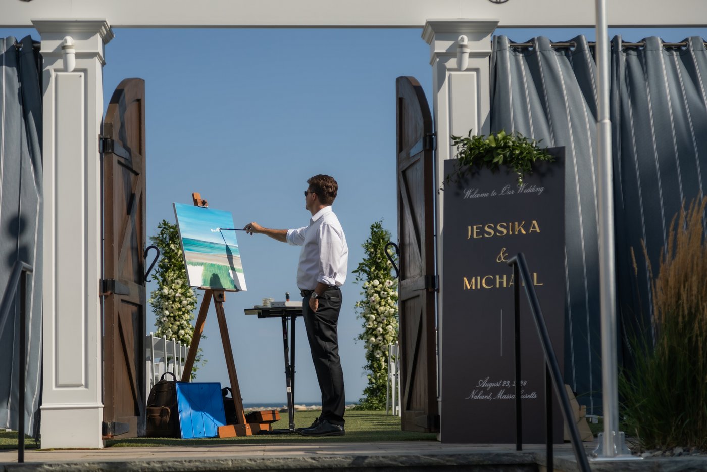 A live artist painting the wedding ceremony scene at Oceanview of Nahant in Massachusetts.