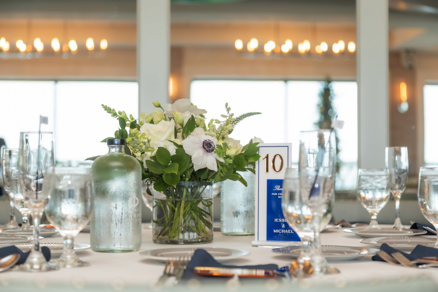 The floral centerpiece and table setting at the Oceanview of Nahant wedding reception