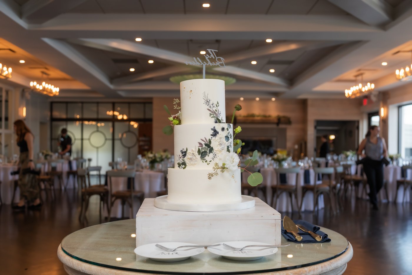 The three-tier wedding cake with floral details at the Oceanview of Nahant wedding