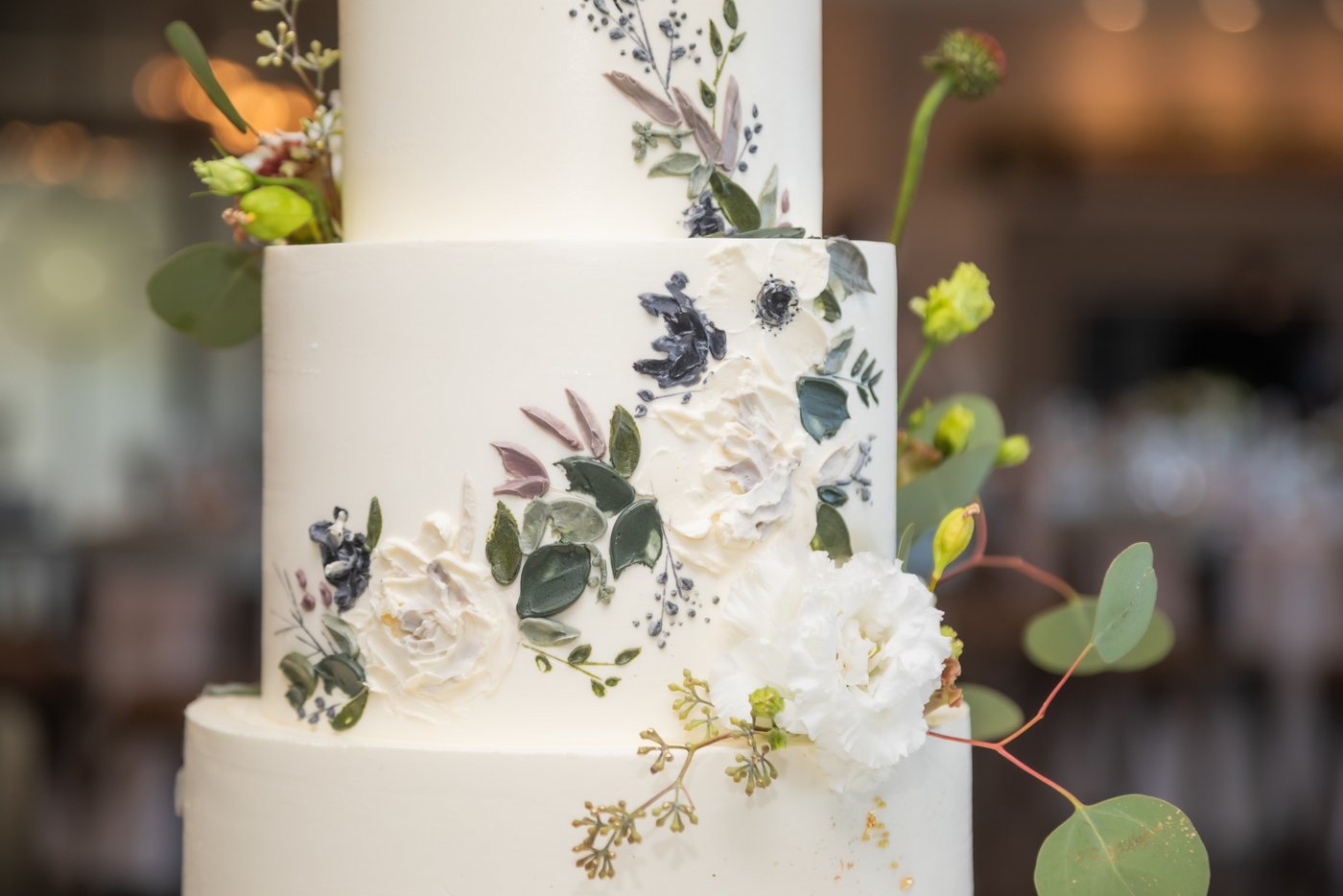 A close-up of the sugar-painted floral details on the wedding cake at Oceanview of Nahant
