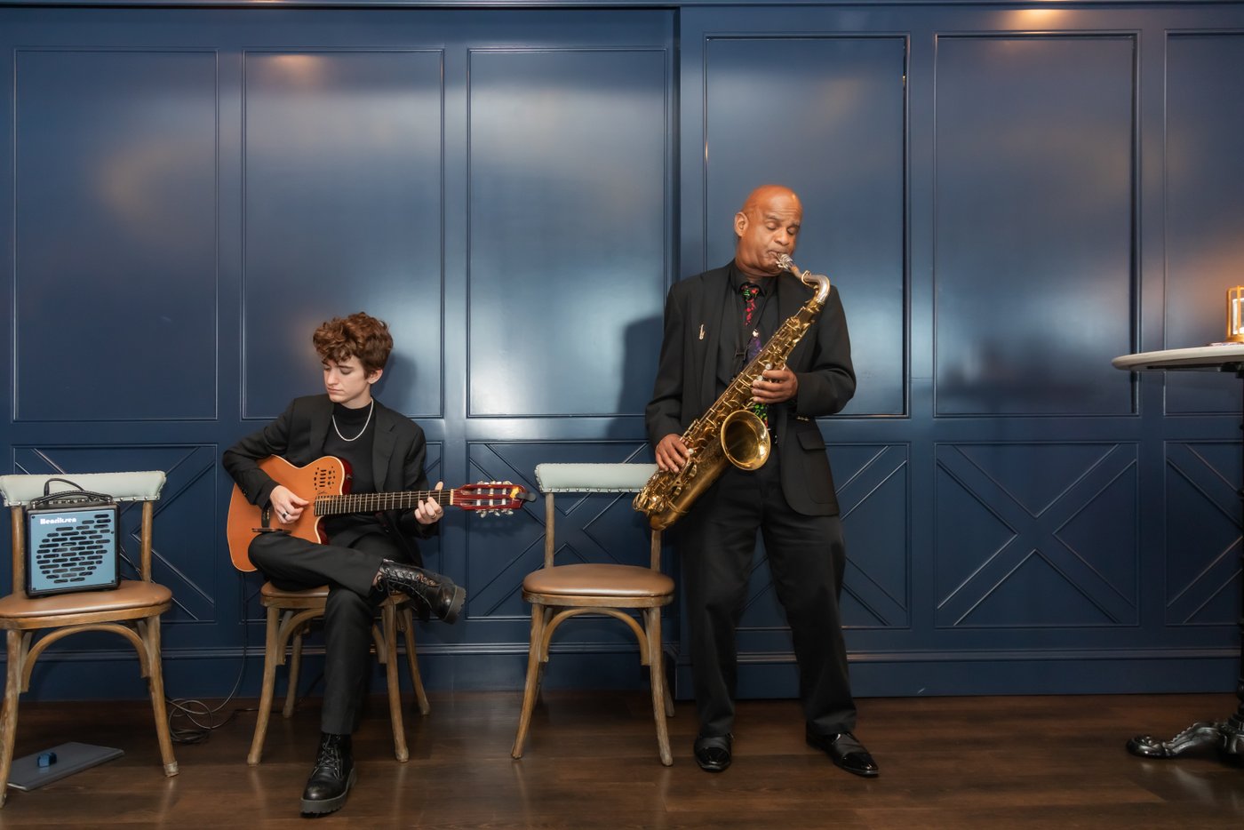 Musicians play the guitar and the saxophone during the cocktail hour at the Oceanview of Nahant wedding