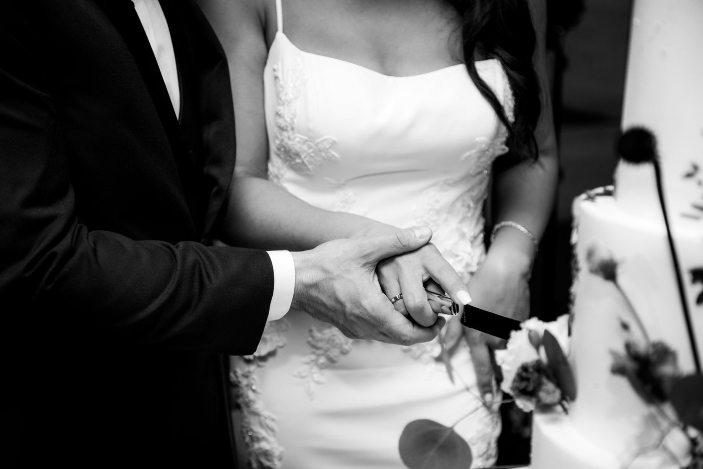Bride and groom cut their wedding cake during the celebration at Oceanview of Nahant in MA.