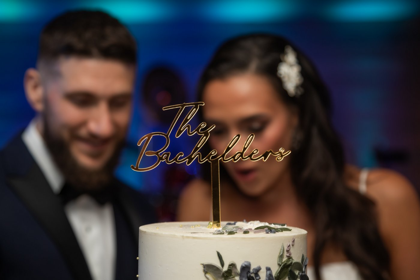 The cake topper with the bride and groom's faces blurred in the background
