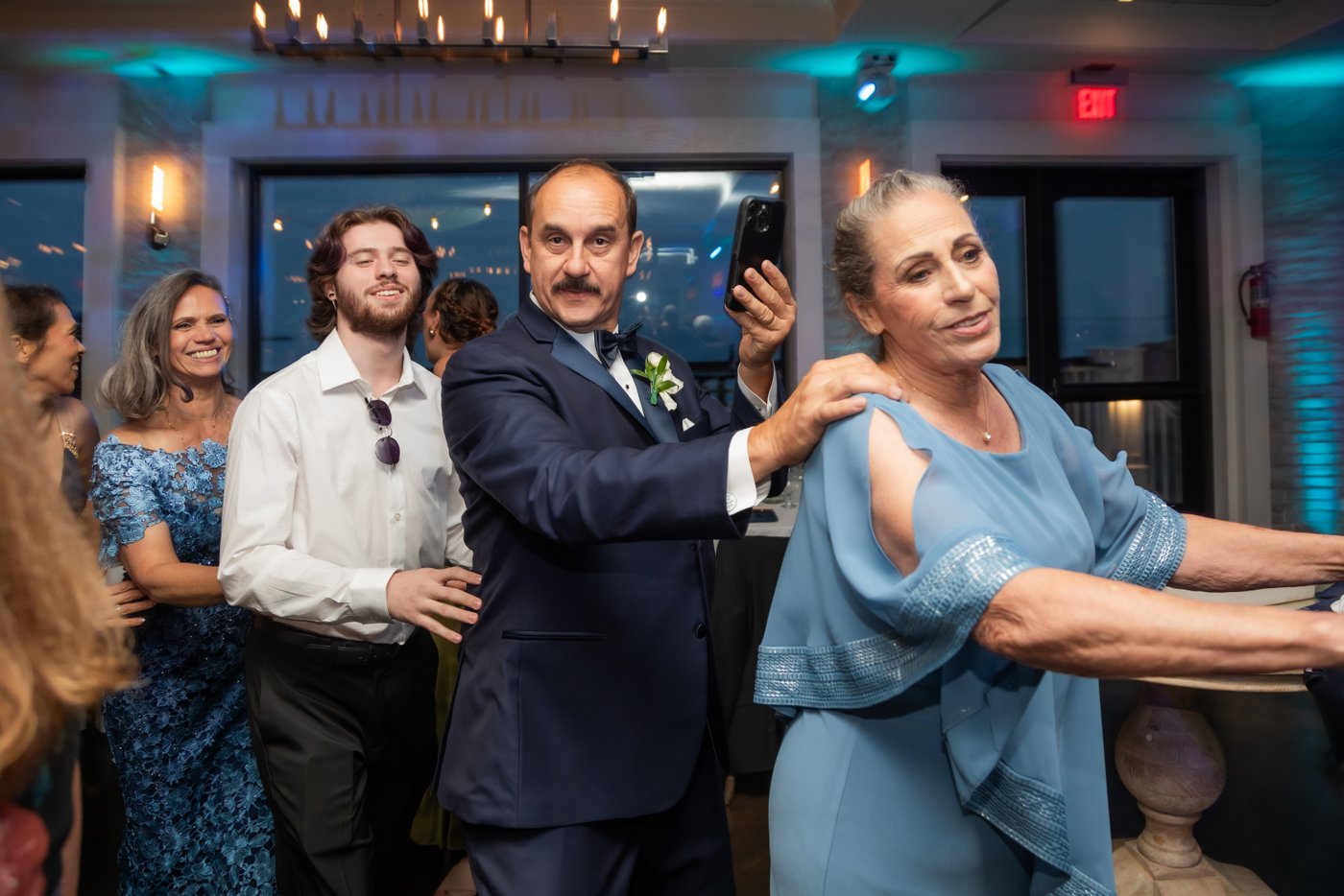 Guests form a train during the reception dancing
