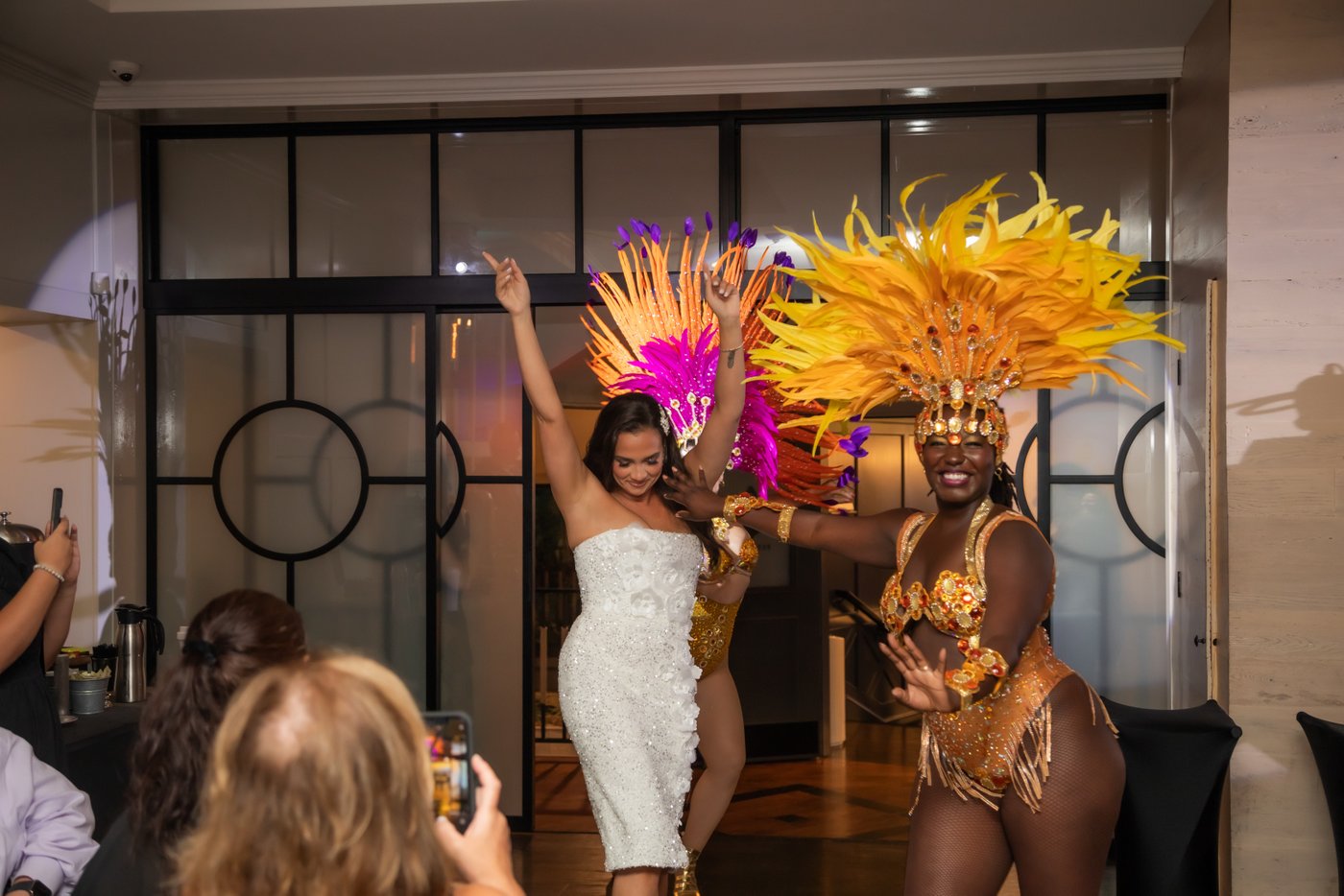 The bride opens the reception hall doors and steps in followed by the Sambaviva samba dancers