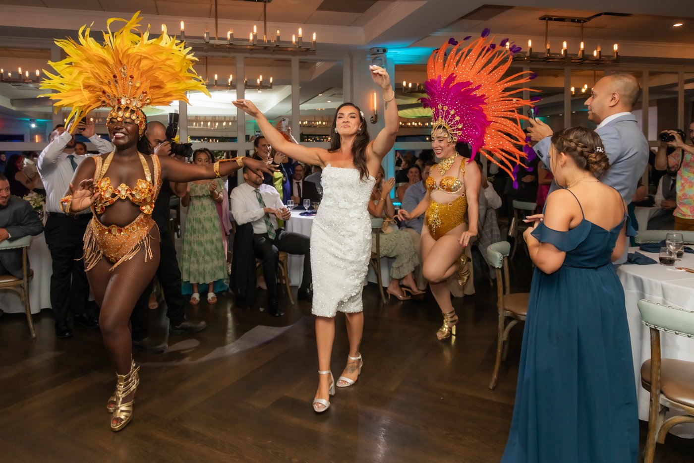 The bride escorts the Sambaviva samba dancers into the wedding reception hall at Oceanview of Nahant
