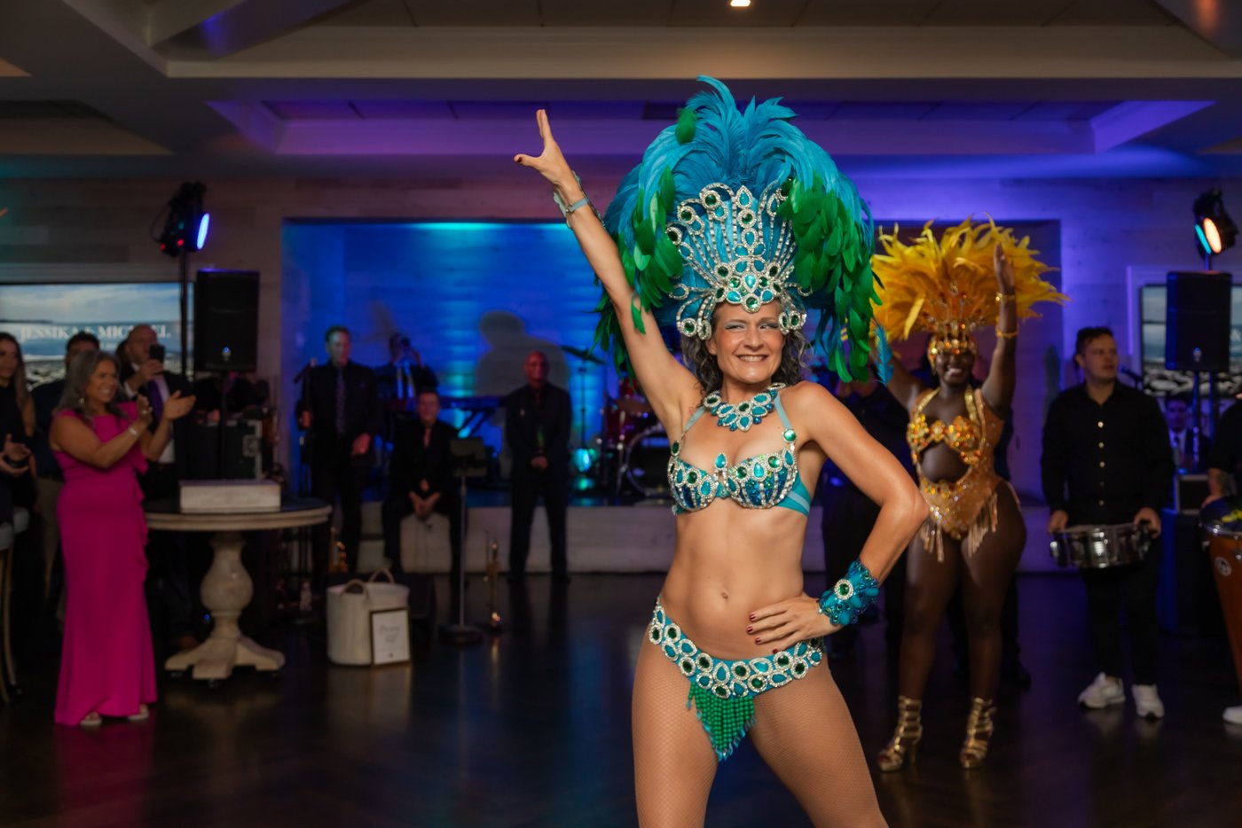 A samba dancer points to the ceiling in a power dance move during the wedding reception at Oceanview of Nahant