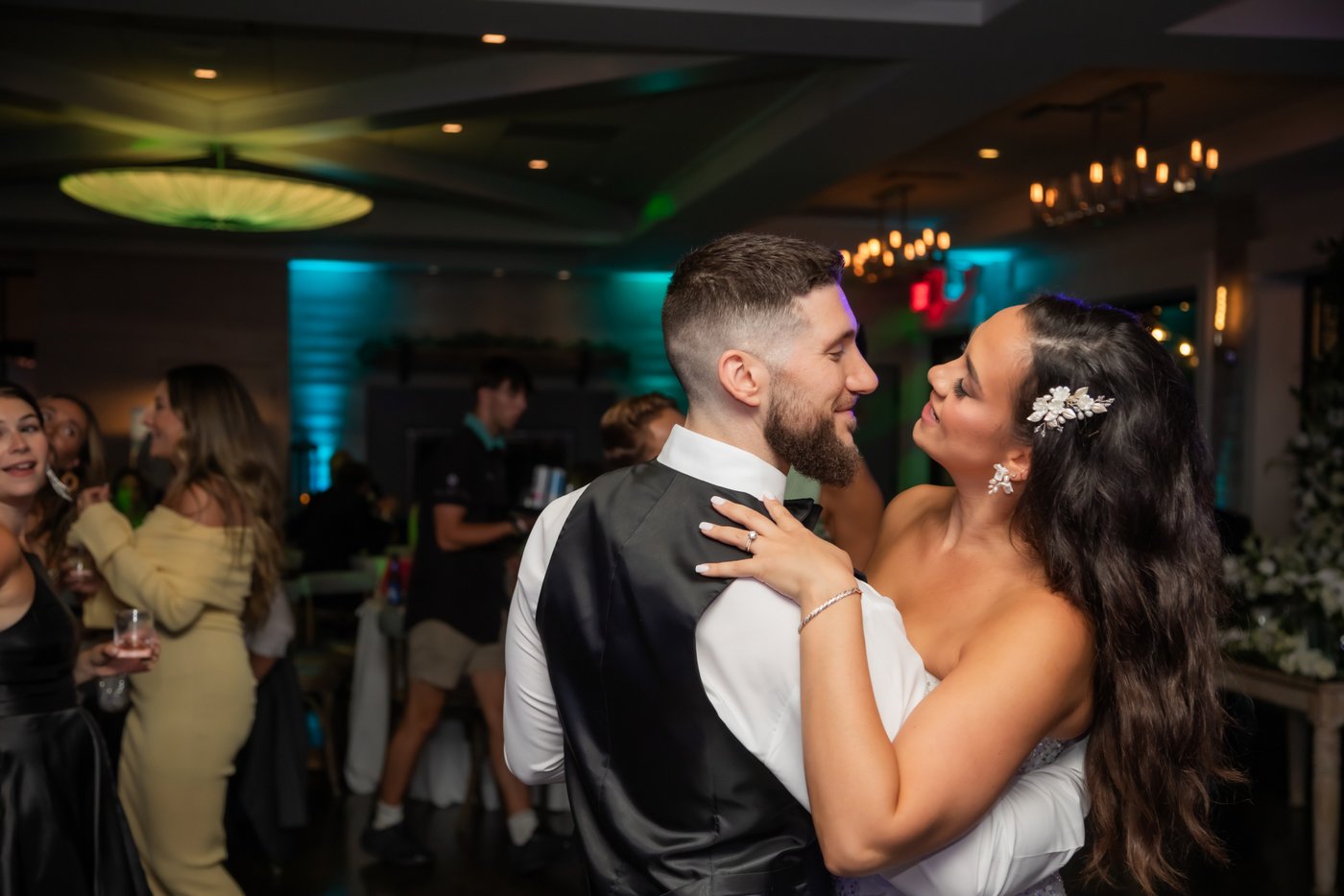 The bride and groom look happy dancing during their Oceanview of Nahant wedding reception with a live band