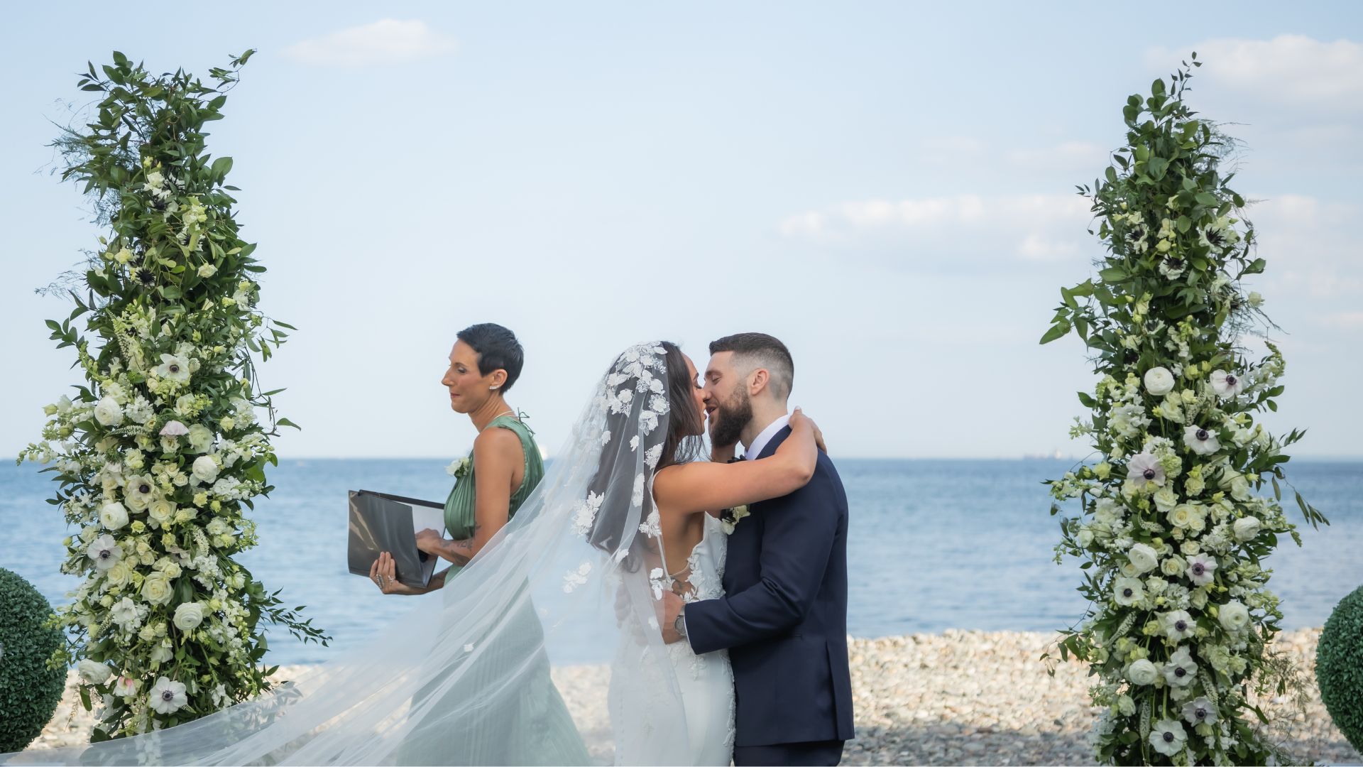 The bide and groom share their first kiss during their waterfront wedding ceremony at Oceanview of Nahant.