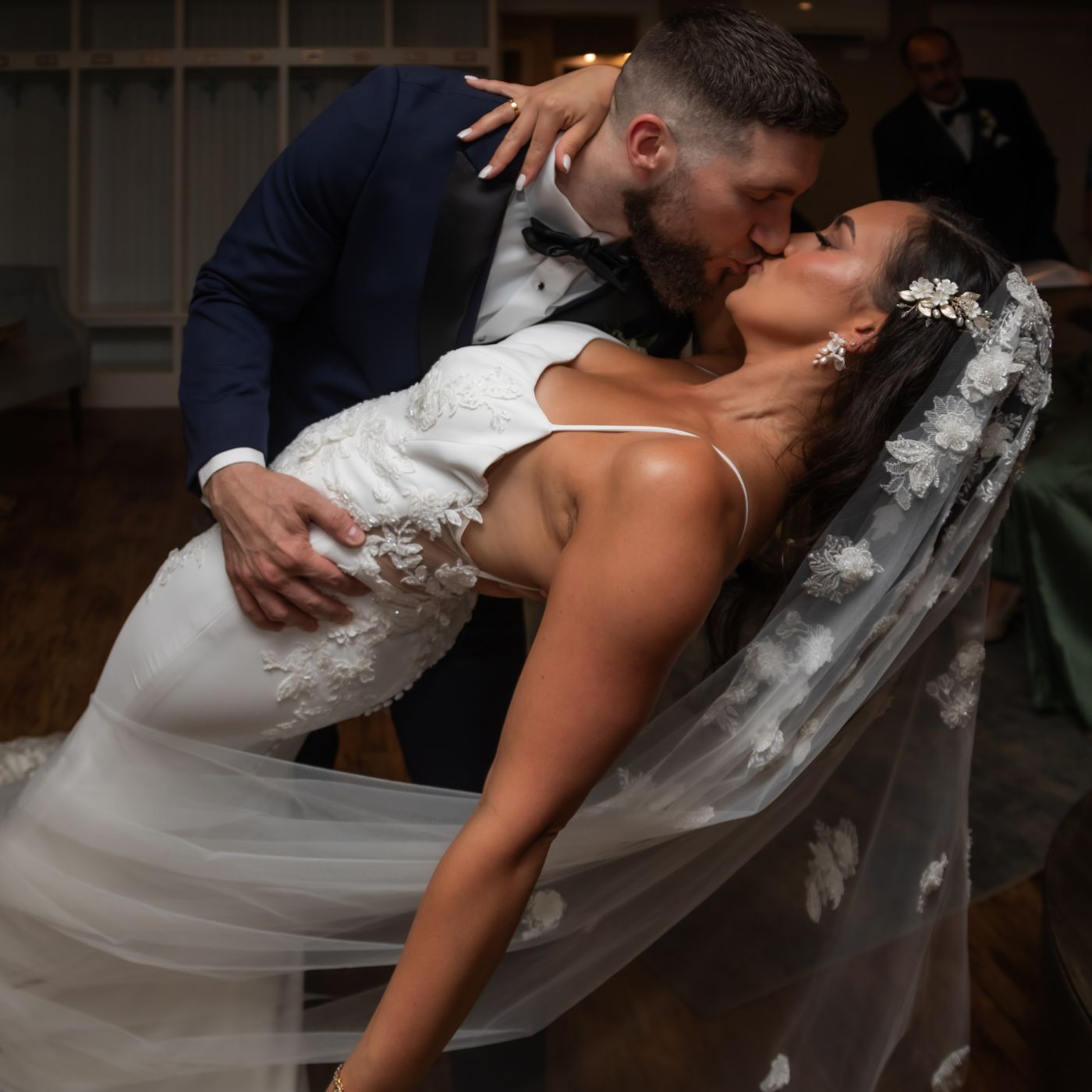 The groom dips the bride in their private bridal suite before their wedding ceremony at Oceanview of Nahant.