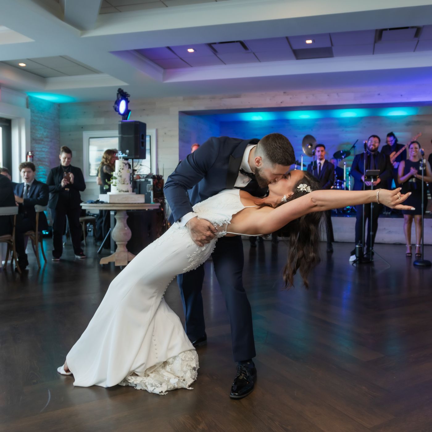 The groom dips the bride during their first dance at their Oceanview of Nahant wedding reception.