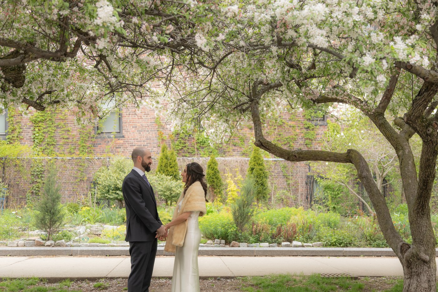 Bride and groom photographed in Boston's Wellington Common Park, on their way to their wedding at SRV Restaurant.